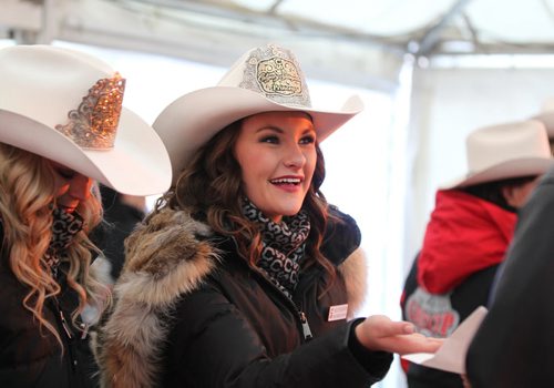 Bailee Billington a 2016 Calgary Stampede Princess, hands out free a free pancake and Sausage in the U of W's street festival tent during the 103rd Grey Cup Festival activities  Saturday.  Standup Nov 28, 2015 Ruth Bonneville / Winnipeg Free Press