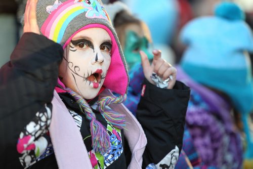 Seven-year-old Izzabella Raine waits with her friends and family on Portage Ave. for the Santa Claus Parade to start after getting her face painted at the Macdon Family zone at the U of W during the day.   Nov 28, 2015 Ruth Bonneville / Winnipeg Free Press