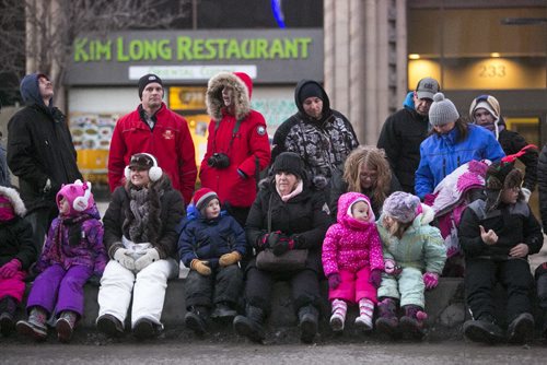 Crowds line up to see the Santa Claus/Grey Cup parade on Portage Avenue in Winnipeg on Saturday, Nov. 28, 2015.   (Mikaela MacKenzie/Winnipeg Free Press)