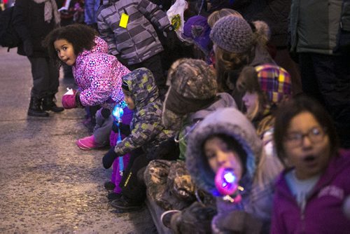 Children lean over to see the first floats at the Santa Claus/Grey Cup parade on Portage Avenue in Winnipeg on Saturday, Nov. 28, 2015.   (Mikaela MacKenzie/Winnipeg Free Press)