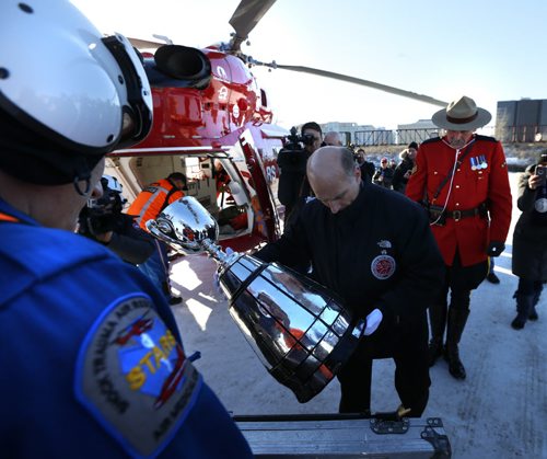 After the fan parade Sunday to The Forks, Jeff McWhinney places the Grey Cup in its case before it is loaded on to the STARS air ambulance and delivered to Investors Group Field  for  the Grey Cup Game. Geoff Kirbyson story Wayne Glowacki / Winnipeg Free Press Nov. 27    2015