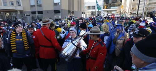 Liam Howe from Toronto takes his turn carrying the Grey Cup on the Fan March to The Forks.This is his fourth March he has had the opportunity to carry the trophy.   Geoff Kirbyson  story.Wayne Glowacki / Winnipeg Free Press Nov. 29    2015