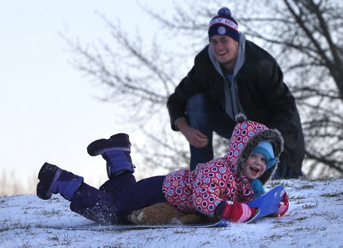 Graham Lusty gives a push to his daughter Kayden Lusty,3, who couldn't get enough sliding at The Forks on the the mild Sunday afternoon.  Wayne Glowacki / Winnipeg Free Press Nov. 29    2015