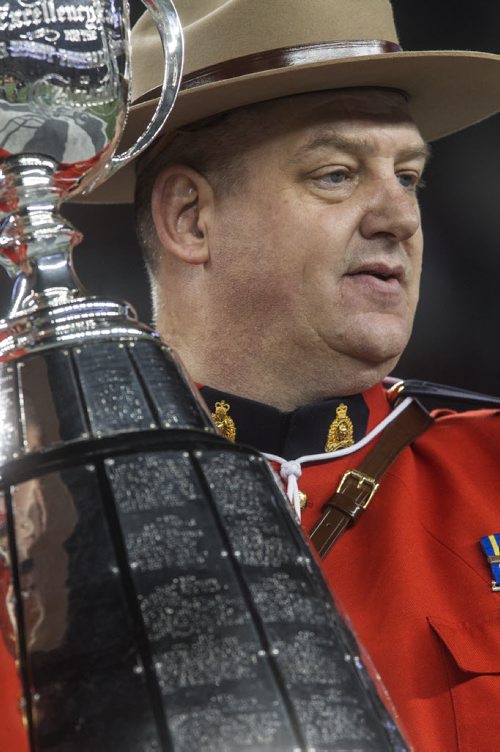 The Grey Cup is guarded by RCMP officers is brought onto the field during the pre-game show at the Grey Cup championship game against the Edmonton Eskimos and the Ottawa Redblacks in Winnipeg, November 29, 2015. 151129 - Sunday, November 29, 2015 -  MIKE DEAL / WINNIPEG FREE PRESS