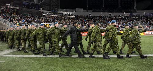 Canadian Military enter the field during the pre-game show at the Grey Cup championship game against the Edmonton Eskimos and the Ottawa Redblacks in Winnipeg, November 29, 2015. 151129 - Sunday, November 29, 2015 -  MIKE DEAL / WINNIPEG FREE PRESS