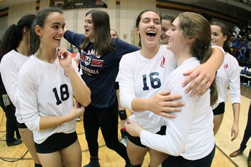 November 30, 2015 - 151130  -  Jenna Cross (18), Julia Tays (16) and Mackenzie DeiCont (7) of the St. Mary's Flames celebrate their win over the Lord Selkirk Royals in the Manitoba High Schools Athletic Association (MHSAA) volleyball final at University of Manitoba Monday, November 30, 2015. John Woods / Winnipeg Free Press