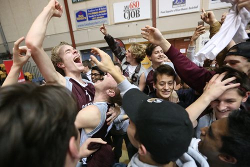 November 30, 2015 - 151130  -  Matthew Stasiuk (1)(c) of the St Paul's Crusaders celebrate with fans and players after defeating the Miles MacDonell Buckeyes in the Manitoba High Schools Athletic Association (MHSAA) volleyball final at University of Manitoba Monday, November 30, 2015. John Woods / Winnipeg Free Press