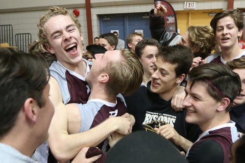 November 30, 2015 - 151130  -  Matthew Stasiuk (1)(L) and Benjamin Hooker (6)(R) of the St Paul's Crusaders celebrate with fans and players after defeating the Miles MacDonell Buckeyes in the Manitoba High Schools Athletic Association (MHSAA) volleyball final at University of Manitoba Monday, November 30, 2015. John Woods / Winnipeg Free Press
