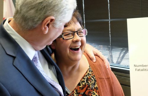 Melody Bodnarchuk, president, Manitoba chapter, MADD Canada hugs Attorney General Gord Mackintosh during a press conference at RCMP 'D' Division headquarters announcing that tougher laws aimed at impaired and distracted drivers came into effect today.  151201 December 01, 2015 MIKE DEAL / WINNIPEG FREE PRESS