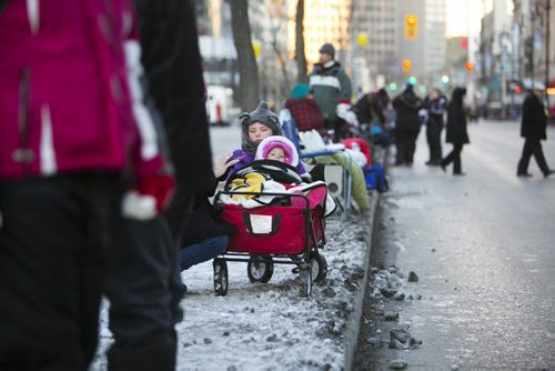 Paisley Walder, one, and her cousin wait for the Santa Claus/Grey Cup parade on Portage Avenue in Winnipeg on Saturday, Nov. 28, 2015.   (Mikaela MacKenzie/Winnipeg Free Press)