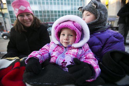 Paisley Walder, one, waits for the Santa Claus/Grey Cup parade on Portage Avenue in Winnipeg on Saturday, Nov. 28, 2015.   (Mikaela MacKenzie/Winnipeg Free Press)