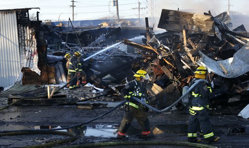 Winnipeg Fire Fighters were still on the scene late in the day Tuesday working on a fire at the JMax Auto Centre on Pembina Hwy. that broke out Monday night. Many vehicles inside the shop were damaged. Wayne Glowacki / Winnipeg Free Press Dec.1 2015