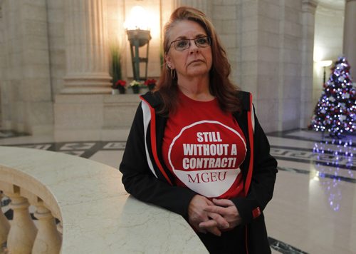 Michelle Gawronsky poses for a photo in the Manitoba Legislature Tues. afternoon. She wears a shirt saying "Still no contract". BORIS MINKEVICH / WINNIPEG FREE PRESS  DEC 1, 2015