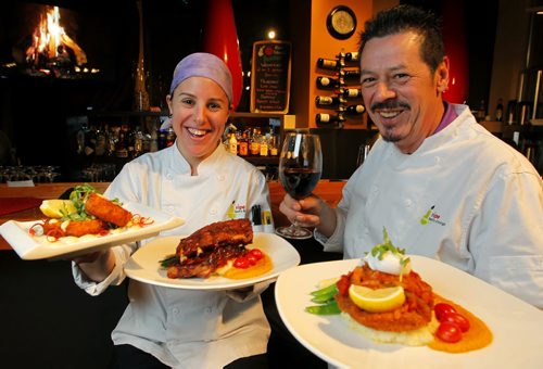RESTAURANT REVIEW - RIPE on Corydon. (L-R) Sous Chef Judith Aronovitch and owner/head chef Tom Pitt. They hold (left to right) salmon cakes, ribs, and veal. BORIS MINKEVICH / WINNIPEG FREE PRESS  DEC 1, 2015
