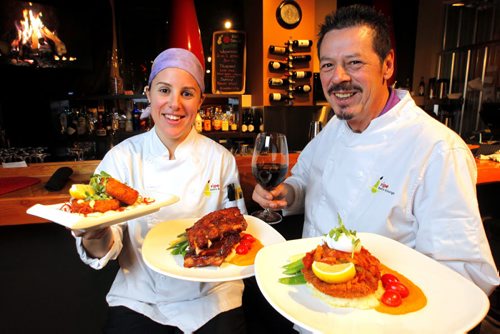 RESTAURANT REVIEW - RIPE on Corydon. (L-R) Sous Chef Judith Aronovitch and owner/head chef Tom Pitt. They hold (left to right) salmon cakes, ribs, and veal. BORIS MINKEVICH / WINNIPEG FREE PRESS  DEC 1, 2015