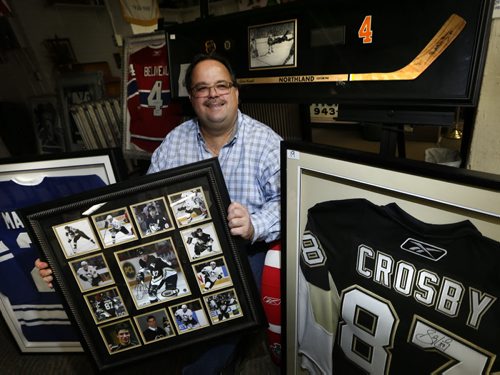 Jason Kaye, Manager and part owner of Kaye's Auction holds a frame with Sidney Crosby photographs surrounded by signed jerseys of Jean Béliveau, Frank Mahovlich, Sidney Crosby. Also in back is the framed Bobby Orr signed replica hockey stick and the famous flying Orr photograph taken after scoring the Stanley Cup winning goal in 1970.  Kaye's is auctioning off a bunch of memorabilia in support of the Selkirk and District Community Foundation. It's willed to the auction by Bob Jefferson.¤ Scott Billeck story   Wayne Glowacki / Winnipeg Free Press Dec. 2  2015