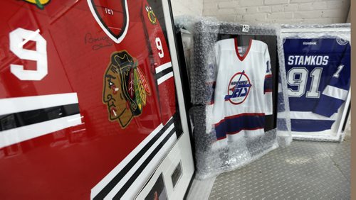 From left, framed and signed Bobby Hull, Teemu Selanne and Steven Stamkos jerseys at Kaye's Auction. Kaye's is auctioning off a bunch of memorabilia in support of the Selkirk and District Community Foundation. It's willed to the auction by Bob Jefferson. Scott Billeck story   Wayne Glowacki / Winnipeg Free Press Dec. 2  2015