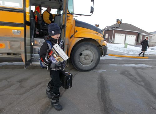 NIVERVILLE, MB - (right in the back)Terri Firlotte welcomes her 12 year old son Josh from the school bus at their home. Josh is on the bus over an hour to get home from his french immersion school in the neighbouring town. BORIS MINKEVICH / WINNIPEG FREE PRESS  DEC 2, 2015