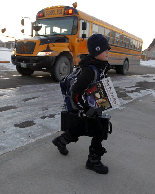 NIVERVILLE, MB - 12 year old son Josh gets home from school by school bus at his house home. Josh is on the bus over an hour to get home from his french immersion school in the neighbouring town. BORIS MINKEVICH / WINNIPEG FREE PRESS  DEC 2, 2015