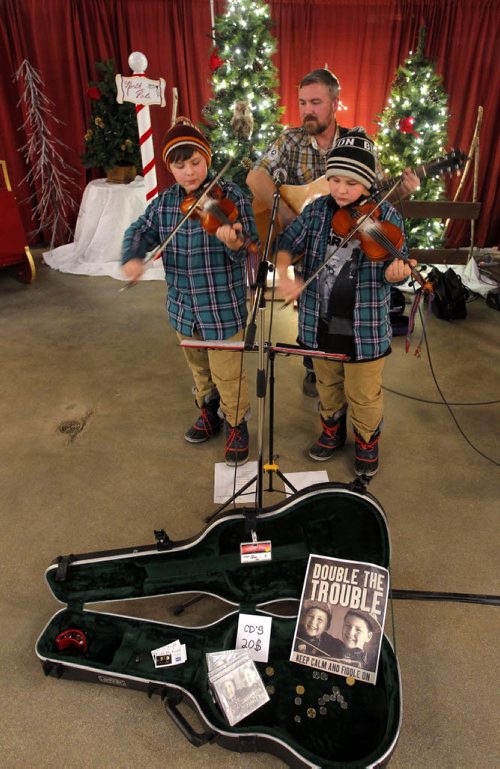 WINNIPEG, MB - The Forks Market Holiday Bazaar. The Forks Market is kicking off the holiday season with a fun shopping event for all. The Wrigley family band called Double the Trouble. L-R Aidan, Rob, and Luc. The kids are 11 year old twins. BORIS MINKEVICH / WINNIPEG FREE PRESS  DEC 3, 2015