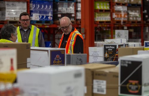 Manitoba Liquor & Lotteries CEO John Stinson (right) with Jason Gray Manager of the Distribution Centre at the Buffalo Place Distribution Centre. 151203 - Thursday, December 3, 2015 -  MIKE DEAL / WINNIPEG FREE PRESS