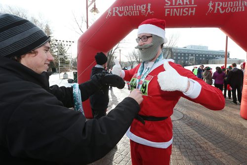 December 5, 2015 - 151205  -  Santa, a.k.a. Alan McGreevy  gets a medal at the finish line of the Salvation Army Santa Shuffle Saturday, December 5, 2015. John Woods / Winnipeg Free Press