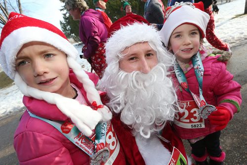 December 5, 2015 - 151205  -  Santa, a.k.a. Scott McCullouch poses for a photo with Jasmine (7) and Isabel Gerbrand (5) during the Salvation Army Santa Shuffle Saturday, December 5, 2015. John Woods / Winnipeg Free Press