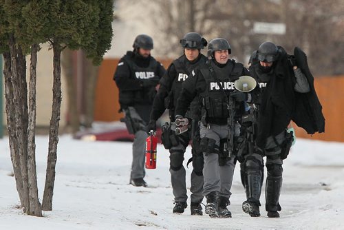 December 5, 2015 - 151205  -  Police detain three people from a home in the 600 block of Adsum Saturday, December 5, 2015. John Woods / Winnipeg Free Press