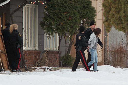 December 5, 2015 - 151205  -  Police detain three people from a home in the 600 block of Adsum Saturday, December 5, 2015. John Woods / Winnipeg Free Press