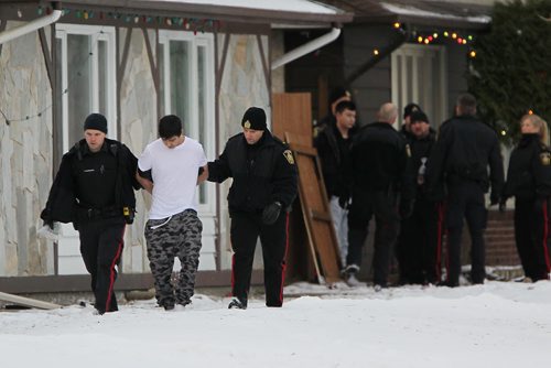 December 5, 2015 - 151205  -  Police detain three people from a home in the 600 block of Adsum Saturday, December 5, 2015. John Woods / Winnipeg Free Press