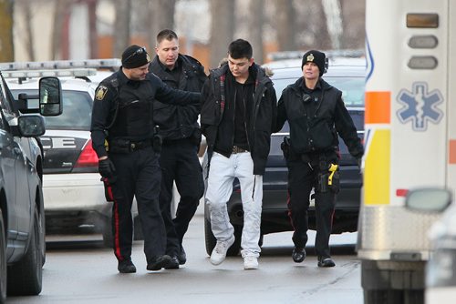 December 5, 2015 - 151205  -  Police detain three people from a home in the 600 block of Adsum Saturday, December 5, 2015. John Woods / Winnipeg Free Press