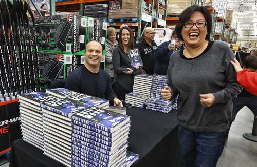 Brenda Frogg laughs while her favourite hockey legend Tie Domi signs his book for her at the Costco on McGillivray Boulevard Sunday afternoon Tie was signing copies of his memoirs Shiftwork. 151206 December 06, 2015 Mike Deal / Winnipeg Free Press
