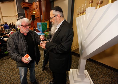 December 6, 2015 - 151206  -  David Rich and Rabbi Avrohom Altein light the first candle on the Menorah for the first night of Chanukah at the Jewish Learning Centre Sunday, December 6, 2015. John Woods / Winnipeg Free Press