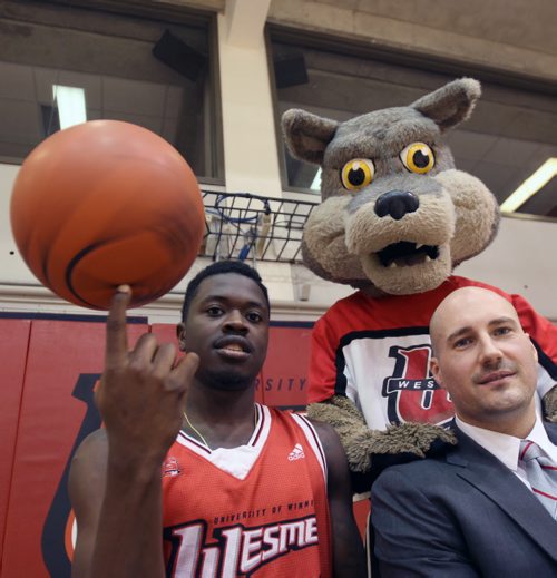 Winnipeg Wesmen star guard Denzel Lynch-Blair, left, with head coach Mike Raimbault and Wesmen Mascot Wes-Lee Coyote to promote upcoming  49th annual Wesmen Classic Basketball tournament- See Melissa Martin StoryDec 07, 2015   (JOE BRYKSA / WINNIPEG FREE PRESS)
