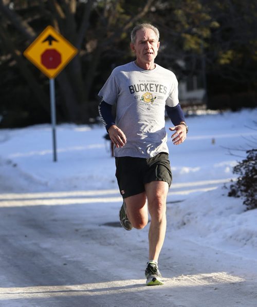 Retired teacher Brent Willows dresses for the above normal temperatures Monday afternoon as he jogs down Larchdale Cres. on his 7.5 km run. Wayne Glowacki / Winnipeg Free Press Dec. 7  2015