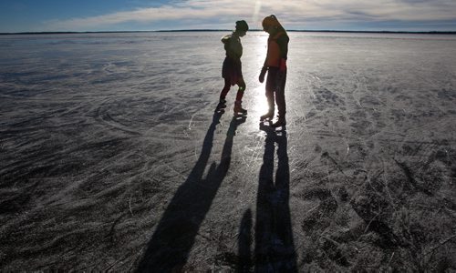 The whole of Clear Lake has frozen flat and almost perfectly clear which many are saying is a very rare event. Sisters Lauryn and Sam Kuzyk skate on the clear ice of Clear Lake Monday afternoon. 151207 - Monday, December 7, 2015 -  MIKE DEAL / WINNIPEG FREE PRESS