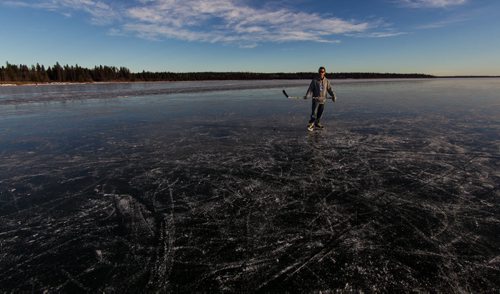 The whole of Clear Lake has frozen flat and almost perfectly clear which many are saying is a very rare event. Reporter Geoff Kirbyson skates on the clear ice of Clear Lake Monday afternoon. 151207 - Monday, December 7, 2015 -  MIKE DEAL / WINNIPEG FREE PRESS