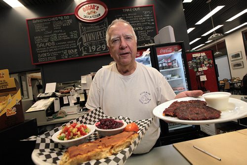 Larry Brown at Oscar's Deli show's off the Cheese Pie (left) and Potatoe/Beet Latke. See Marion's review. December 7, 2015 - (Phil Hossack / Winnipeg Free Press)