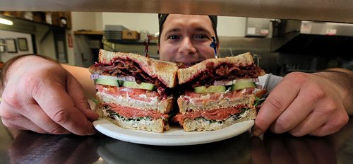 Chef Hari Haidau shows off an Oscar's Smoked Salmon club sandwich. See Marion's review. December 7, 2015 - (Phil Hossack / Winnipeg Free Press)