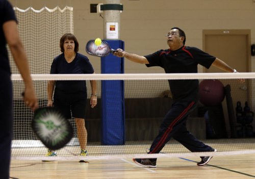49.8 PULSE - Pickle ball.   Pickle ball player Paul Diana returns ball  with doubles partner Carol Chmil,left, in doubles game at the Wellness Institute at Seven Oaks Hospital Tuesday morning.   Wayne Glowacki / Winnipeg Free Press Dec. 8  2015