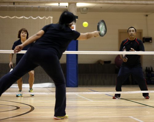 49.8 PULSE - Pickle ball.   Pickle ball player Chie Ominga returns ball against  Paul Diana and Carol Chmil,left, in doubles game at the Wellness Institute at Seven Oaks Hospital Tuesday morning.   Wayne Glowacki / Winnipeg Free Press Dec. 8  2015