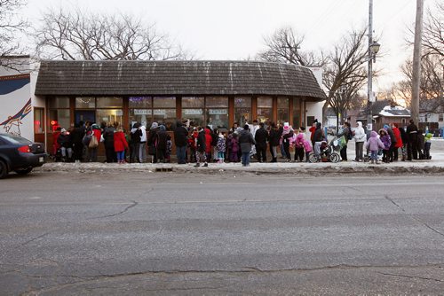 December 8, 2015 - 151208  -  Community members line up to select some gifts at a Christmas pop-up shop at the Indigenous Family Centre Tuesday, December 8, 2015. Think Shift, an advertising agency based in Winnipeg, in partnership with North End Community Renewal Corp. and the Indigenous Family Centre  has set up a pop-up shop in the citys North End where youth and community members are invited to shop for free gifts for family and friends. John Woods / Winnipeg Free Press