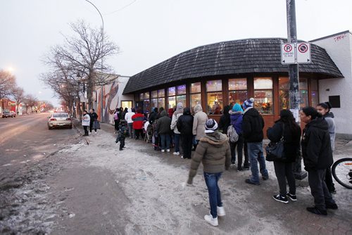 December 8, 2015 - 151208  -  Community members line up to select some gifts at a Christmas pop-up shop at the Indigenous Family Centre Tuesday, December 8, 2015. Think Shift, an advertising agency based in Winnipeg, in partnership with North End Community Renewal Corp. and the Indigenous Family Centre  has set up a pop-up shop in the citys North End where youth and community members are invited to shop for free gifts for family and friends. John Woods / Winnipeg Free Press