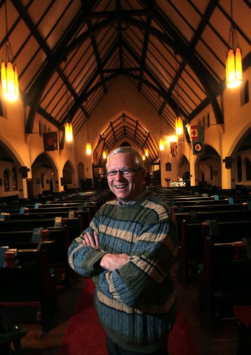 All Saints Anglican Church priest  Brent Neumann poses in the historic sanctuary Tuesday evening. See Randy Turner's tale. December 8, 2015 - (Phil Hossack / Winnipeg Free Press)