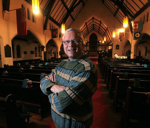 All Saints Anglican Church priest  Brent Neumann poses in the historic sanctuary Tuesday evening. See Randy Turner's tale. December 8, 2015 - (Phil Hossack / Winnipeg Free Press)