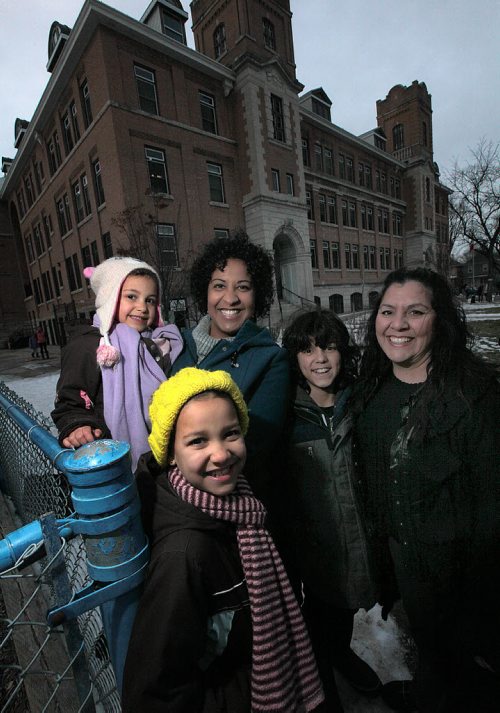 Kathy Heppner (left) holds her daughter Elena (4), Asha (8) poses below, Eugenia Lehmann and her son Keenan (11) pose right. See Nick Martin's story re: Spanish Immersion classes at Earl Grey School..... December 8, 2015 - (Phil Hossack / Winnipeg Free Press)