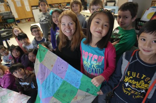 Grade 2 French immersion teacher Annick Bordeaux, centre on chair, at Ecole James Nisbet in the Maples- Her students made a quilt for baby Joy Finnimore. They were touched by the story we ran in September about the baby with the rare medical condition and this is their Christmas project.-See Alex Paul storyDec 10, 2015   (JOE BRYKSA / WINNIPEG FREE PRESS)