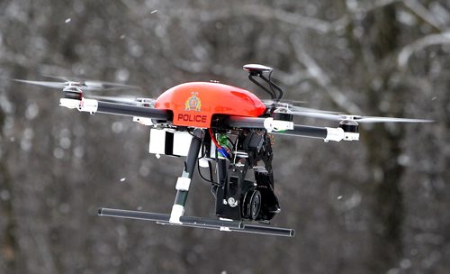 Manitoba RCMP has been using drones for the past four years. Cpl. Kenneth Pinsent  (not in photo) demonstrates a drone flight at Beaudry Park near Headingley. BORIS MINKEVICH / WINNIPEG FREE PRESS DEC 10, 2015