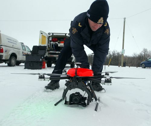 Manitoba RCMP has been using drones for the past four years. Cpl. Kenneth Pinsent demonstrates a drone flight at Beaudry Park near Headingley. BORIS MINKEVICH / WINNIPEG FREE PRESS DEC 10, 2015