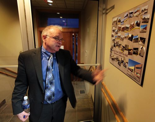 Municipal CAO Brent Olynyk shows off a framed set of photos of the West St Paul Fire Hall is a focal point Thursday as the Municipality accepts an report on confict to interest by former counsellor Dan Garcea. See Bill Redekopp story. December 10, 2015 - (Phil Hossack / Winnipeg Free Press)